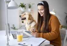 “Pet owner planning monthly pet care budget with dog and cat at home.”
