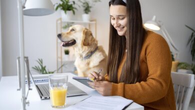 “Pet owner planning monthly pet care budget with dog and cat at home.”