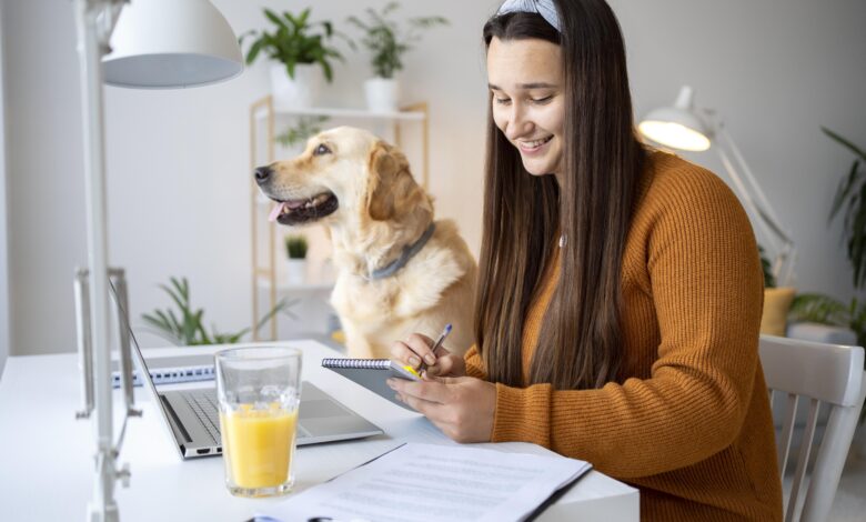 “Pet owner planning monthly pet care budget with dog and cat at home.”